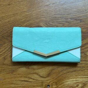 Mint and white trifold wallet.